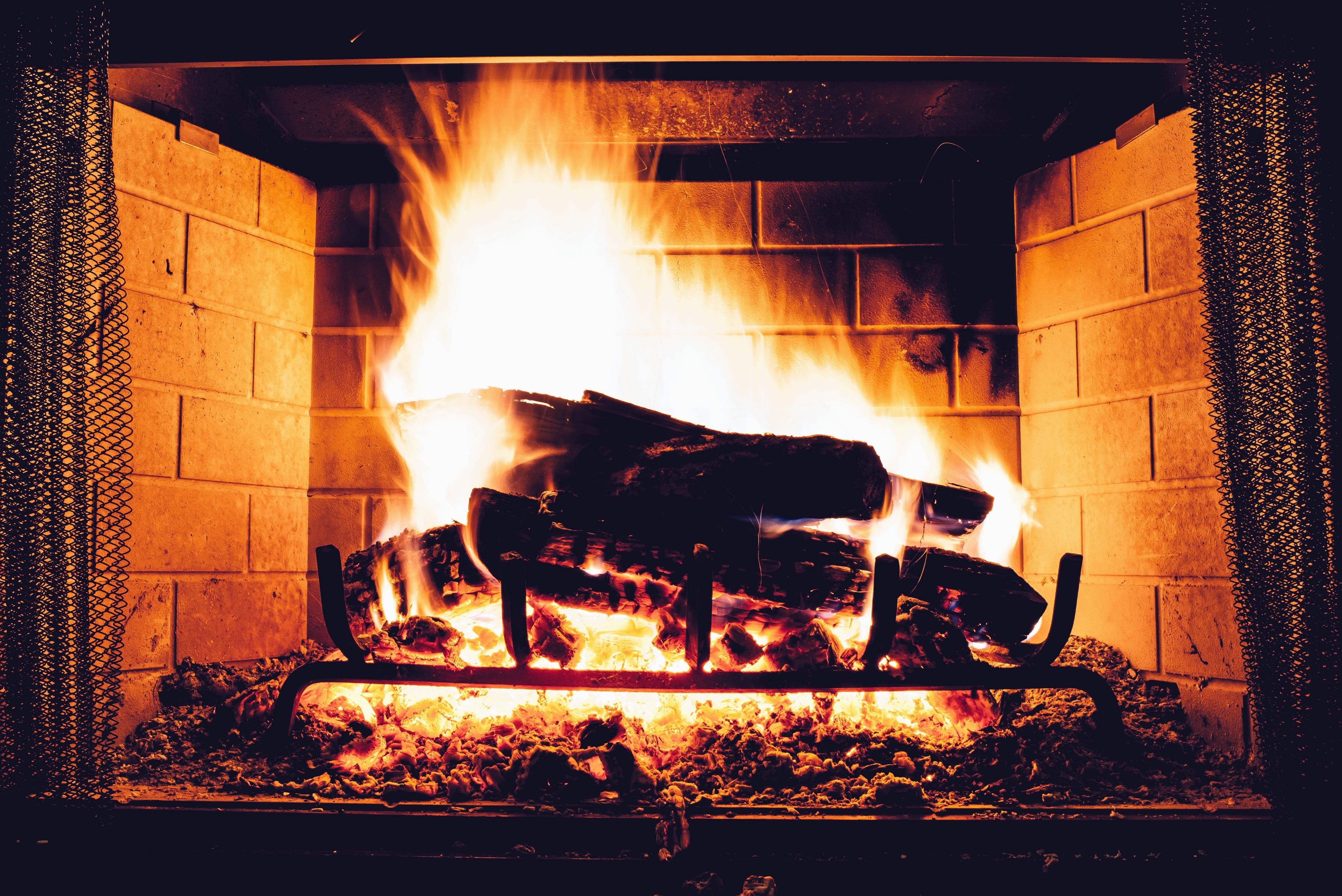A roaring fire in a fireplace