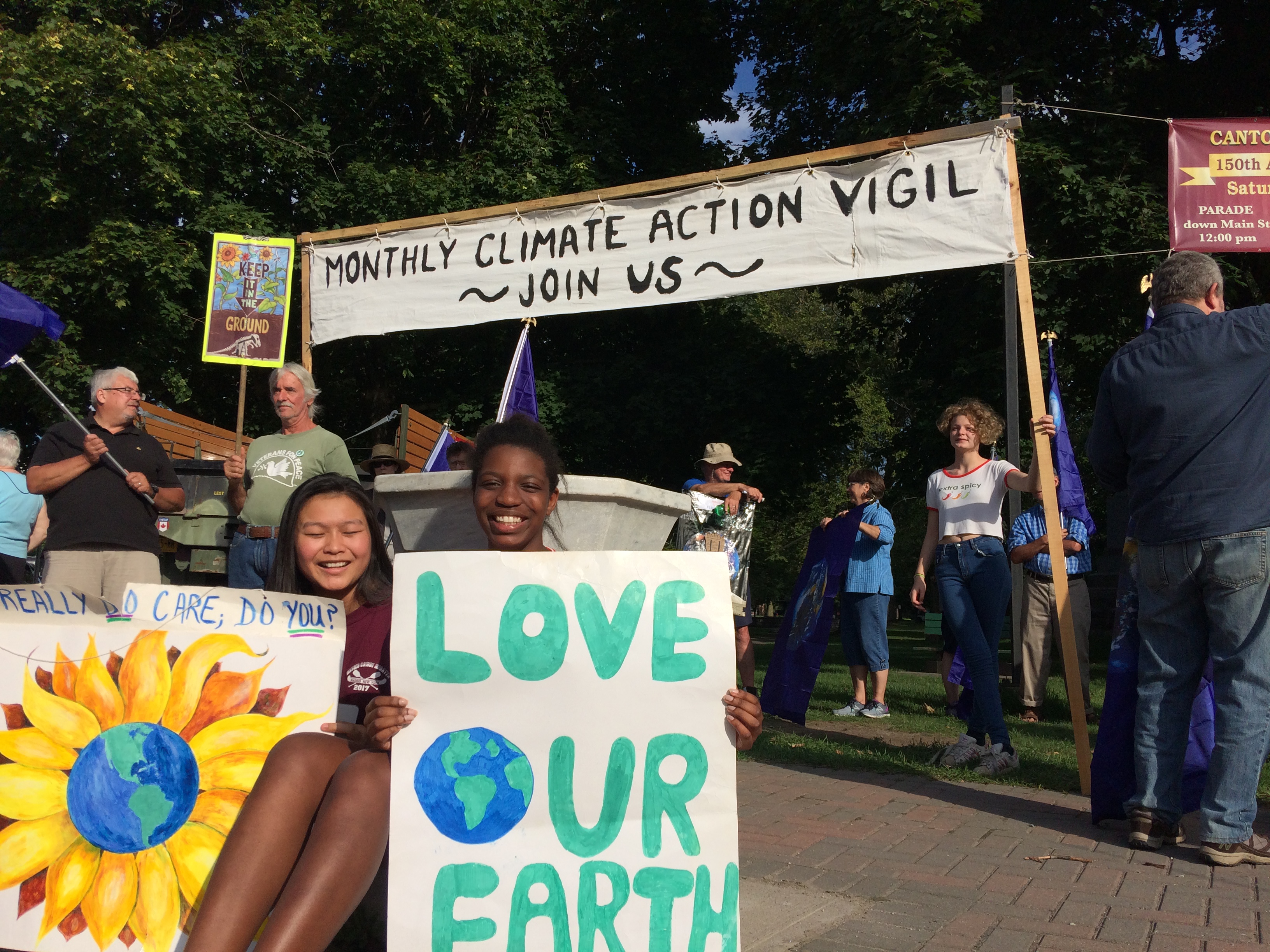 Protesters held homemade signs at the September Monthly Climate Action Vigil.
