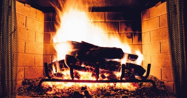 A roaring fire in a fireplace
