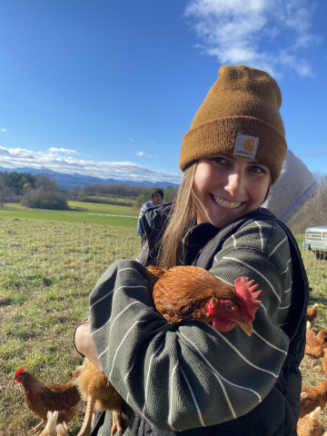 Sage Kehr holding a chicken