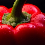 red bell pepper over black background