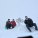 Dan sits at the peak of Whiteface Mountain with two friends in whiteout conditions.