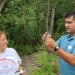 A teacher shows the result from a water sampling kit testing dissolved oxygen.