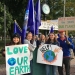 SLU students hold signs protesting climate change.